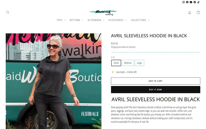 Website page titled Black Sleeveless Hoodie | Machine Washable | Avril – Mermaid Walking Boutique